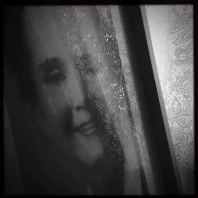 The reflection of lace hanging in the windows of the Rachel Carson homestead can be seen in a portrait of the famous conservationist, who grew up in Springdale, PA, about 17 miles from Pittsburgh, and whose book, Silent Spring, and other works are credited with awakening many to environmental issues. © Annie O'Neill/TDW 2015