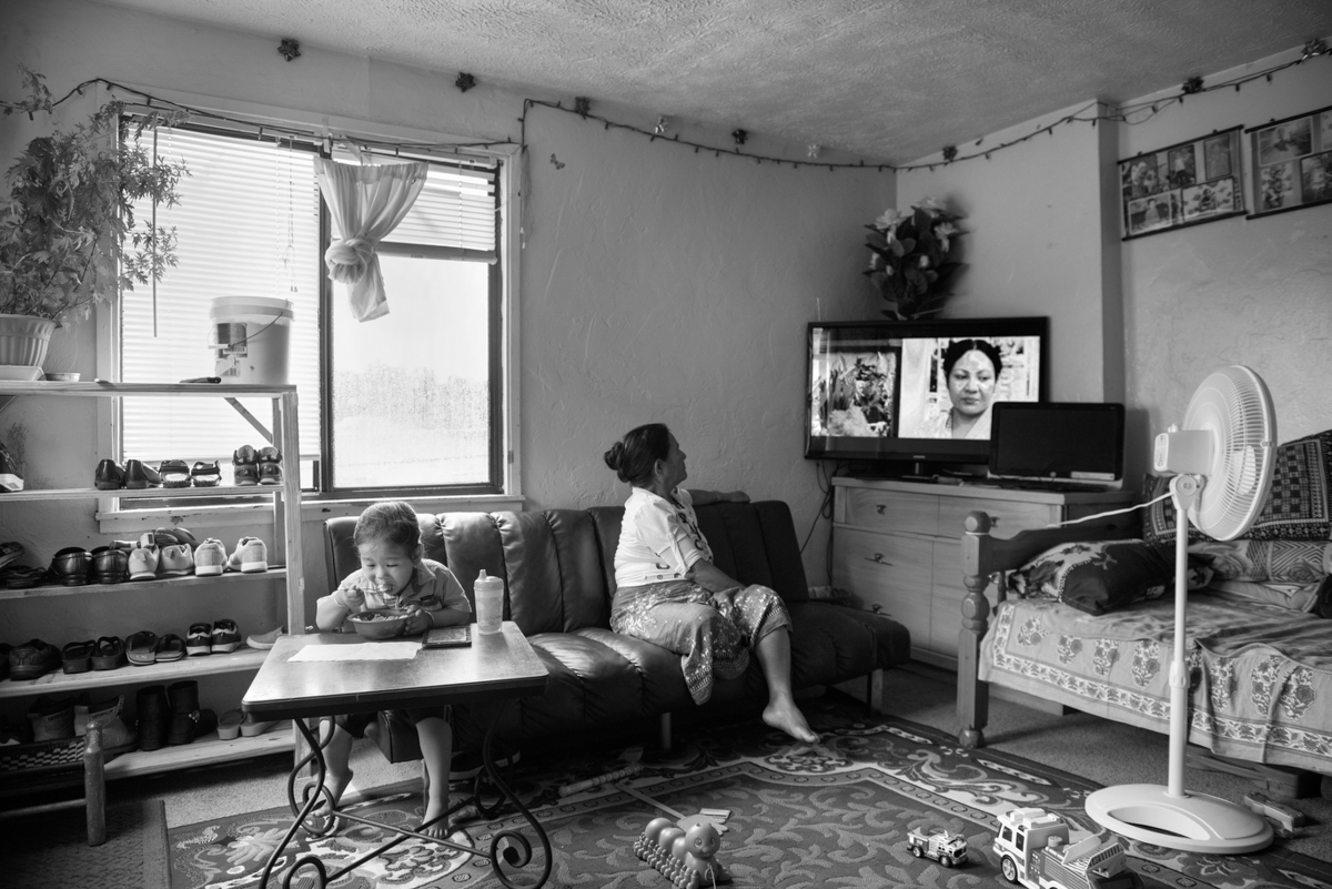  The young boy on the left is the grandson of the lady on the right. The lady on the right immigrated to the US this year with her daughter and son-in-law. She is mesmerized by TV. She had never watched TV until she came to the USA. They have direct 