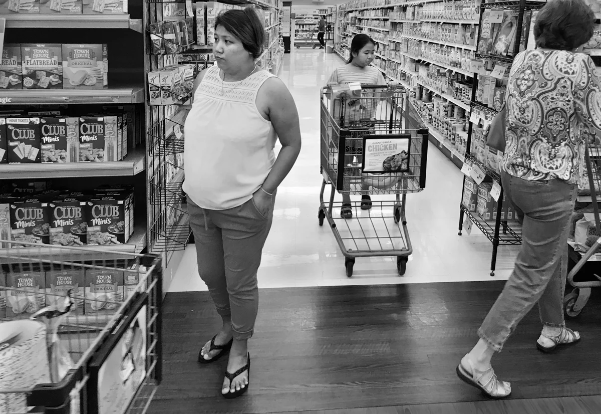 After living in the Brentwood neighborhood of Pittsburgh for three months, Kheena Gurung made her first visit to a large grocery store. She took her niece, Salina Rai, age nine, to help translate and guide her through the store. Kheena seemed overwhelmed and confused at times. © Scott Goldsmith/TDW 2017
