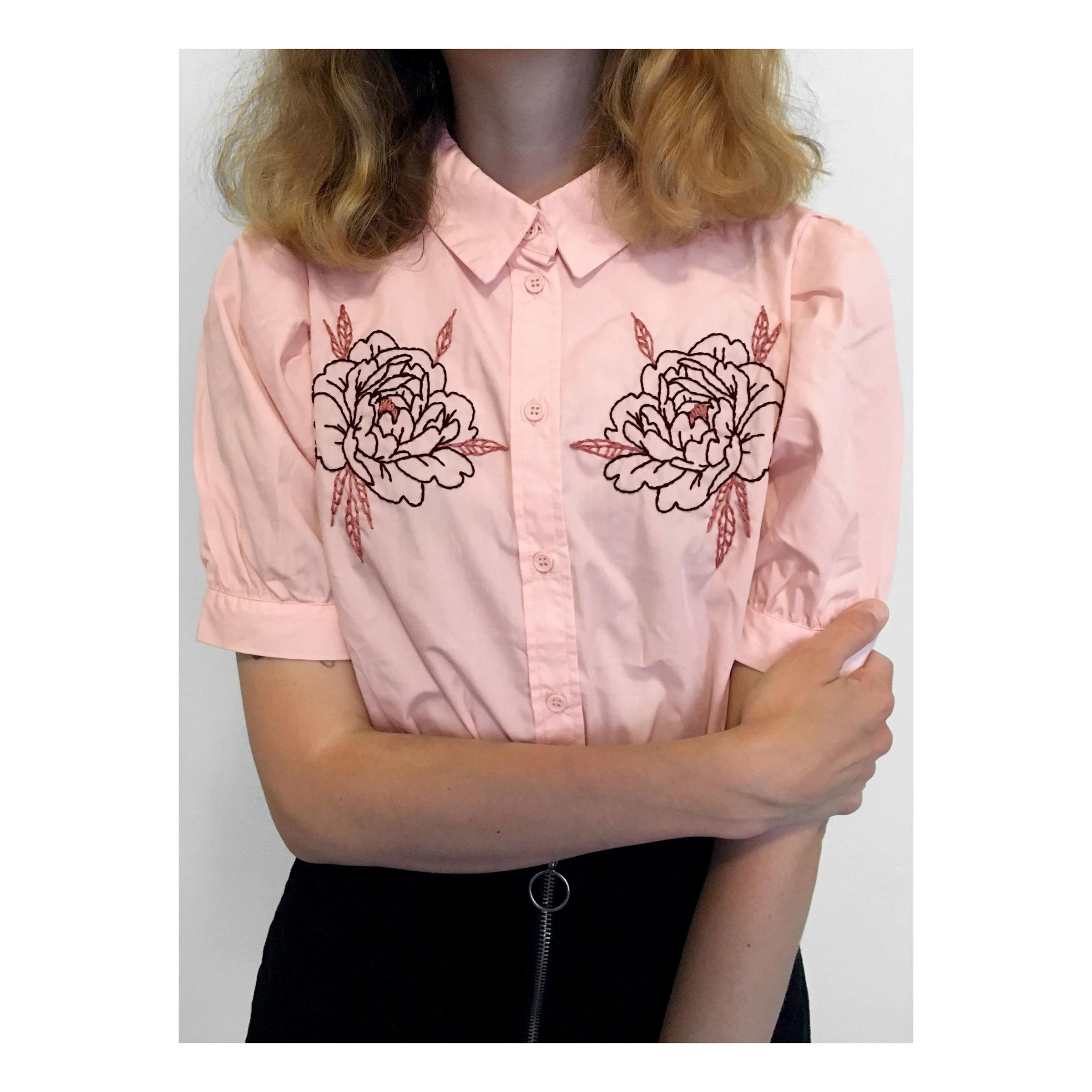 Symmetrical embroidered peonies on button-up shirt.