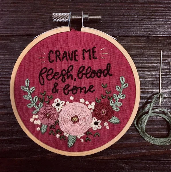 Small, 3" hoop. Some flowers on burgundy cotton with lyrics for lettering practice.