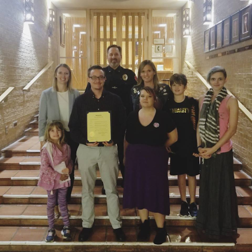 Daniel Bryant-Gawne is pictured holding the proclamation with Denton LGBTQ liaisons Sara Kuechler (leftmost) and Chris Summit (third from left), activist Amber Briggle (on Summit’s left).