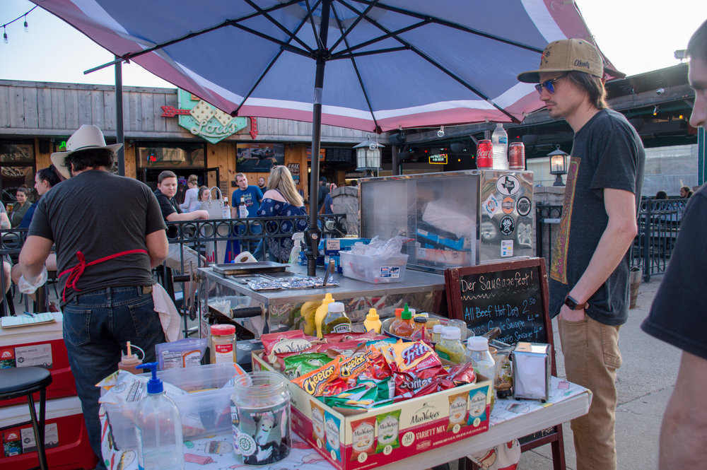  Supporting local small businesses. A hotdog stand selling food for the football fans. 