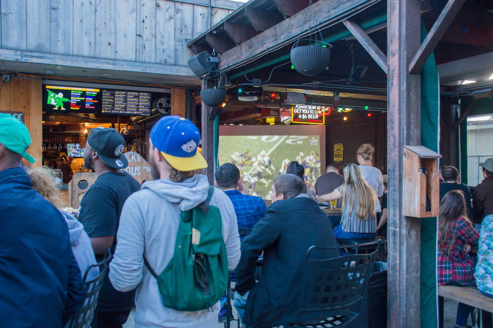  Fans watching the game outside at Lucky Lou’s. 