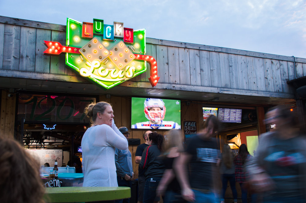  Fans watching the game outside at Lucky Lou’s. 