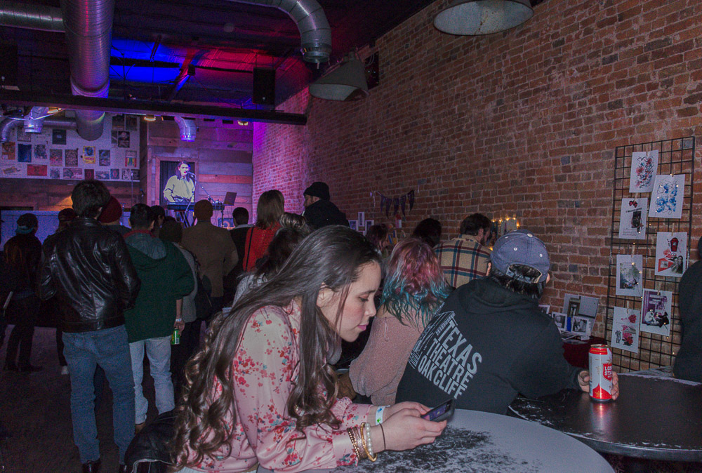  Crowd gathering around the multimedia artists at Andy’s bar, enjoying music, drinks and art. 