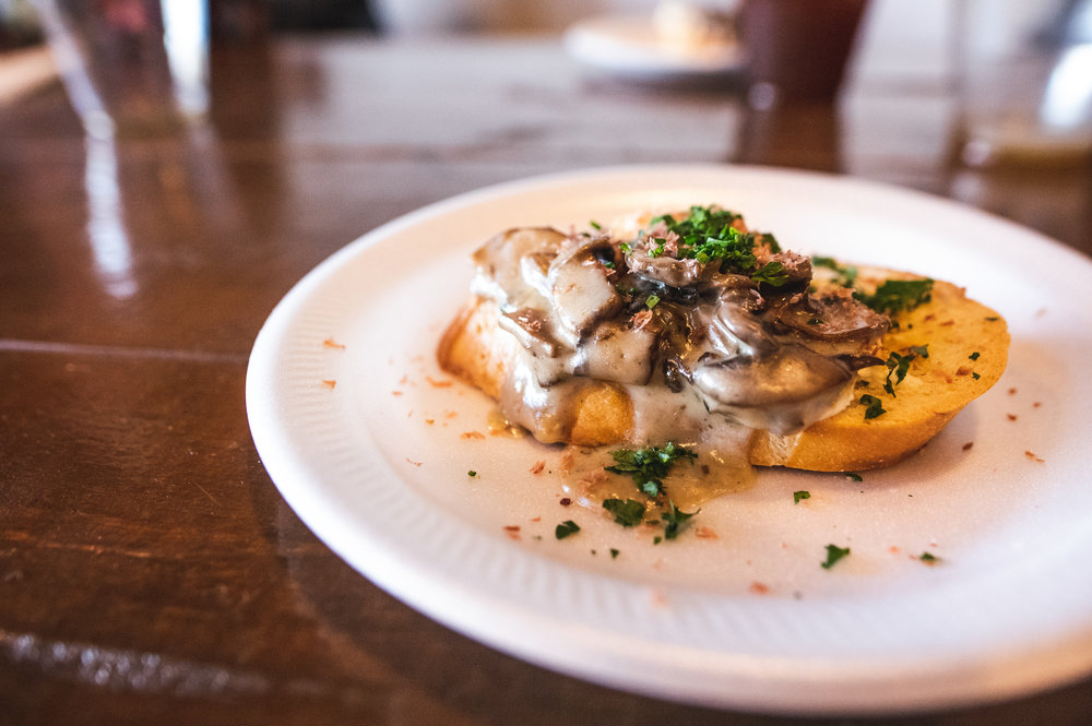  The third course, consisting of Mushroom and Beef Jerky Crostini, paired with Armadillo’s Winterstellar and Ten:One’s Delice De Bourgone. Photo by Garrett Smith. 