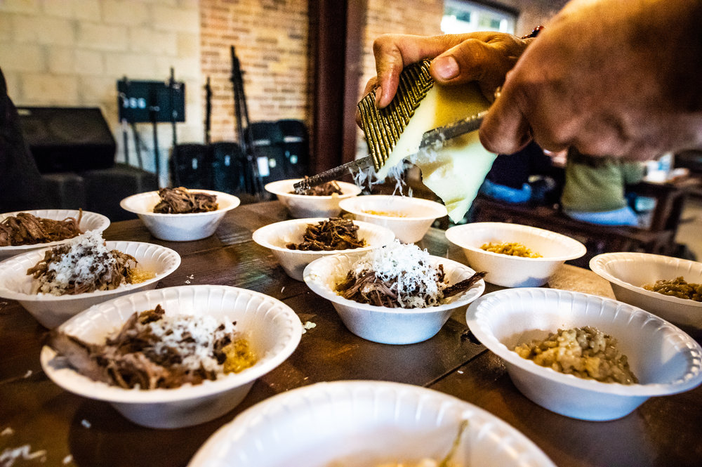  The kitchen staff in action, topping the fifth course - Red Wine Braised Brisket Risotto - with some of Ten:One’s Campo de Montalban. Photo by Garrett Smith. 