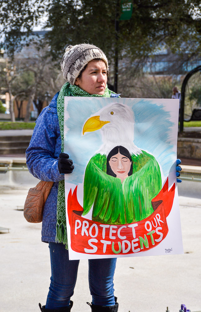  Protestors gathering around the Library Mall with different signs. 