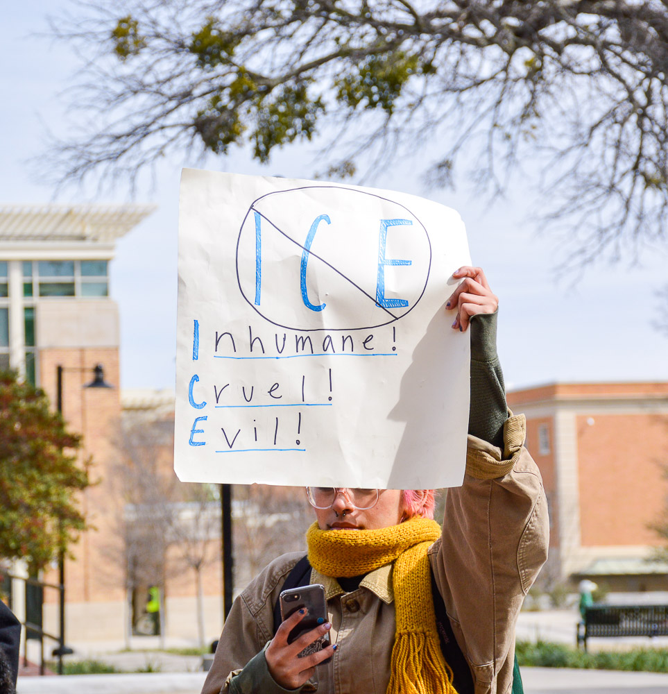  Protestors gathering around the Library Mall with different signs. 