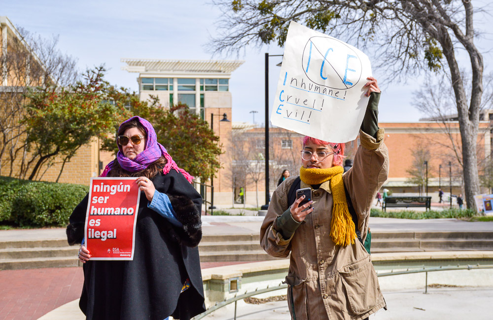  Protestors gathering around the Library Mall with different signs. 