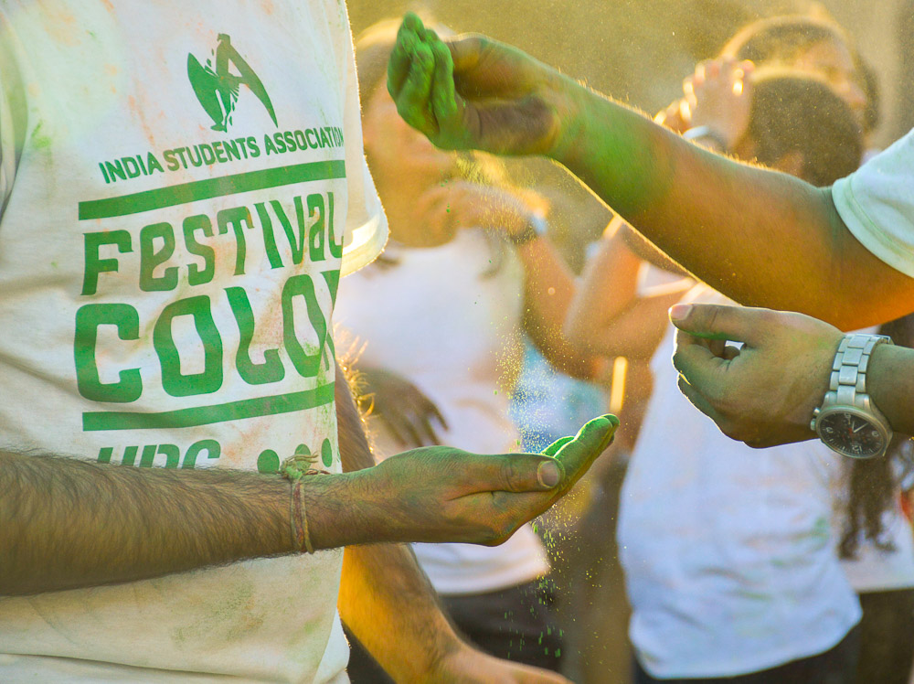  Close-up of hands exchanging the colored powder. 