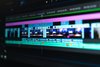 Close-up of a computer screen displaying a video editing timeline with multiple video and audio tracks, color-coded clips, and editing tools.