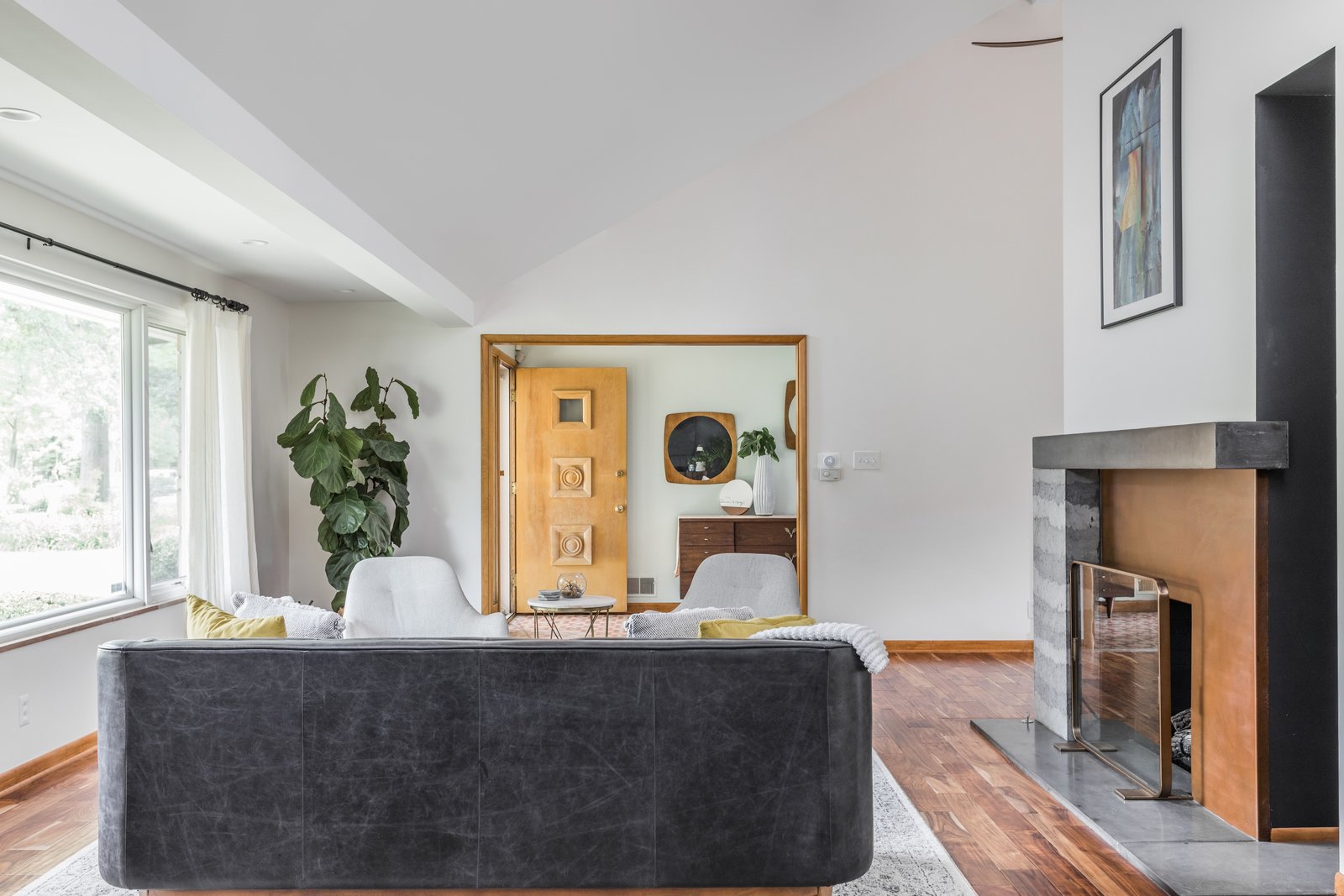 the-new-eight-foot-tall-chimney-though-the-cutout-was-never-a-part-of-their-original-plan-they-now-love-this-unique-feature-as-it-brings-ample-light-into-the-dining-room.jpg