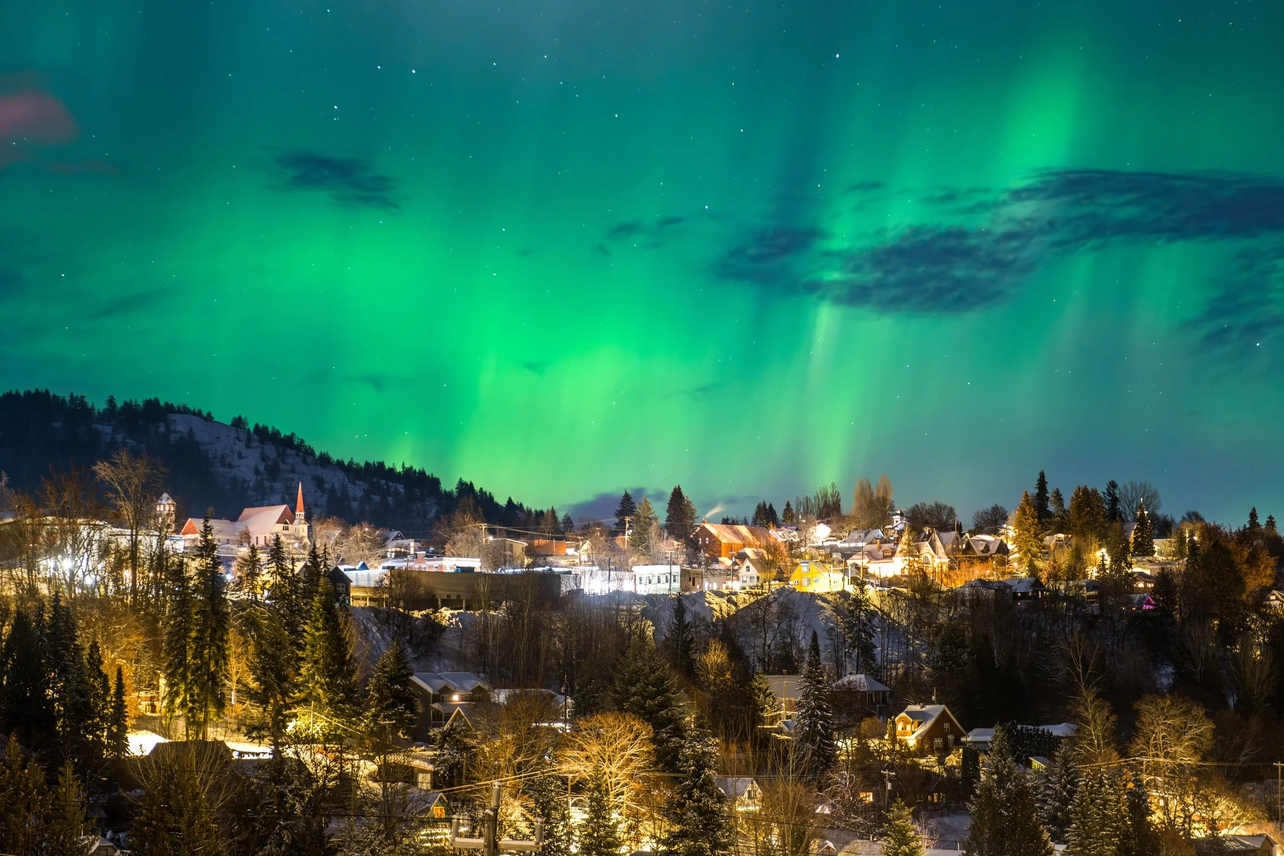 Northern lights dancing above Rossland, British Columbia on a winter night