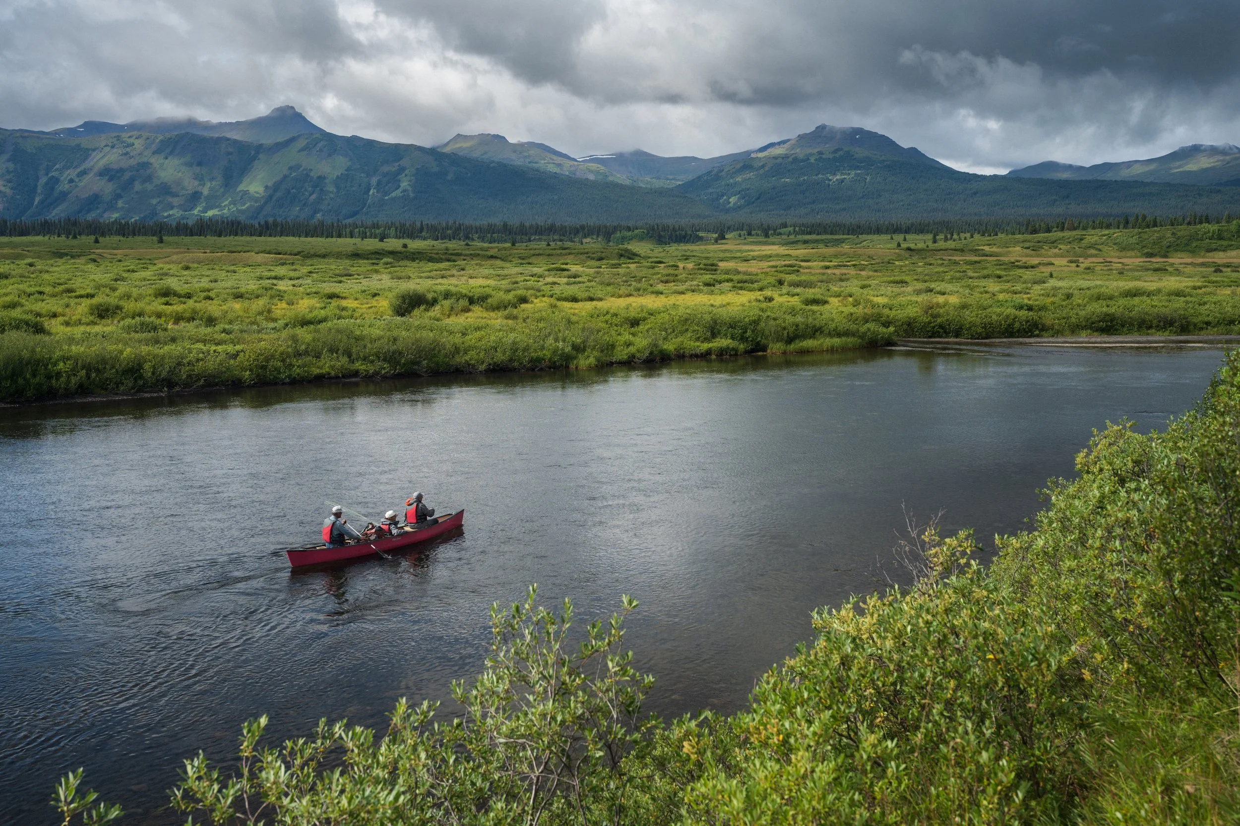 Canoe paddling the upper Stikine River in Spatsizi Plateau Wilderness Provincial Park on a summer day