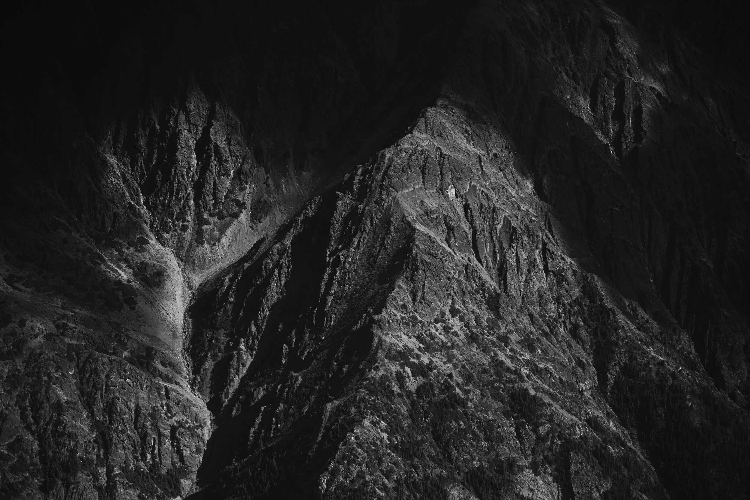 A black and white aerial image of the rugged mountainside of the Eaglenest Range in Spatsizi Provincial Park