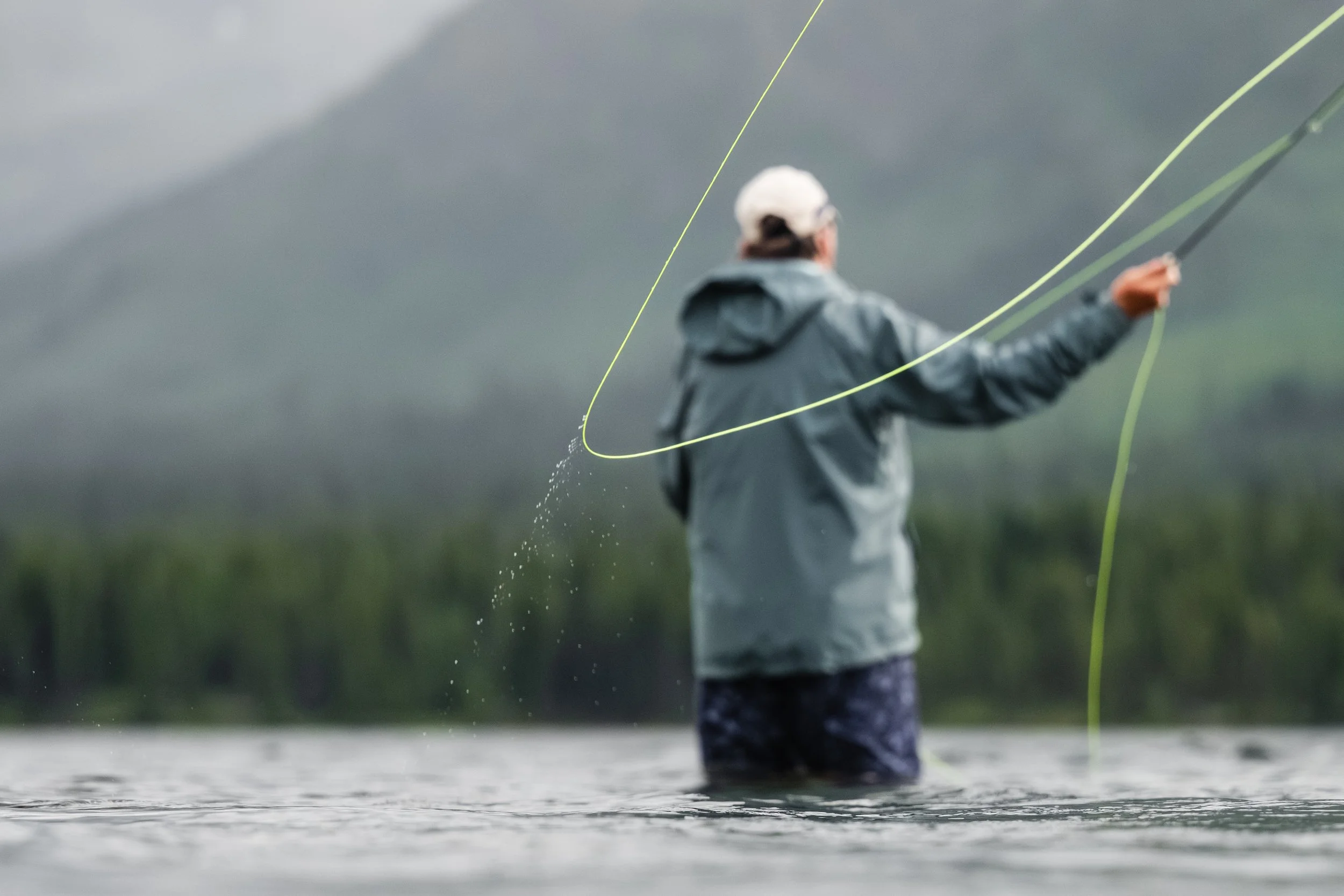 A Fly-fisherman casts out a line in Kitchener Lake within Tatlatui Provincial Park, a remote area of Northwestern British Columbia, Canada