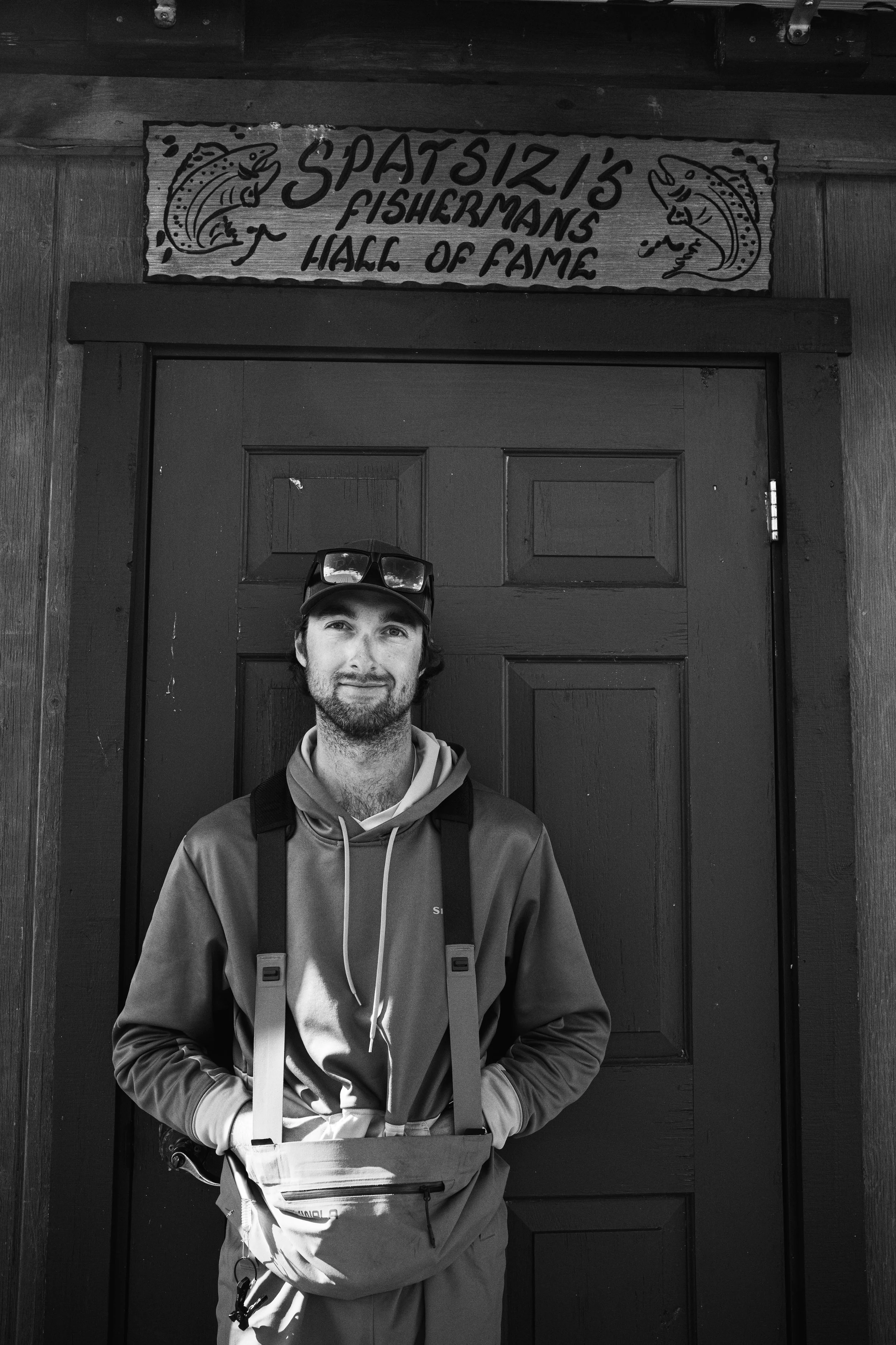 Portrait of a guide in Spatsizi Plateau Provincial Park and a sign that reads, Spatsizi's Fishermans Hall of Fame