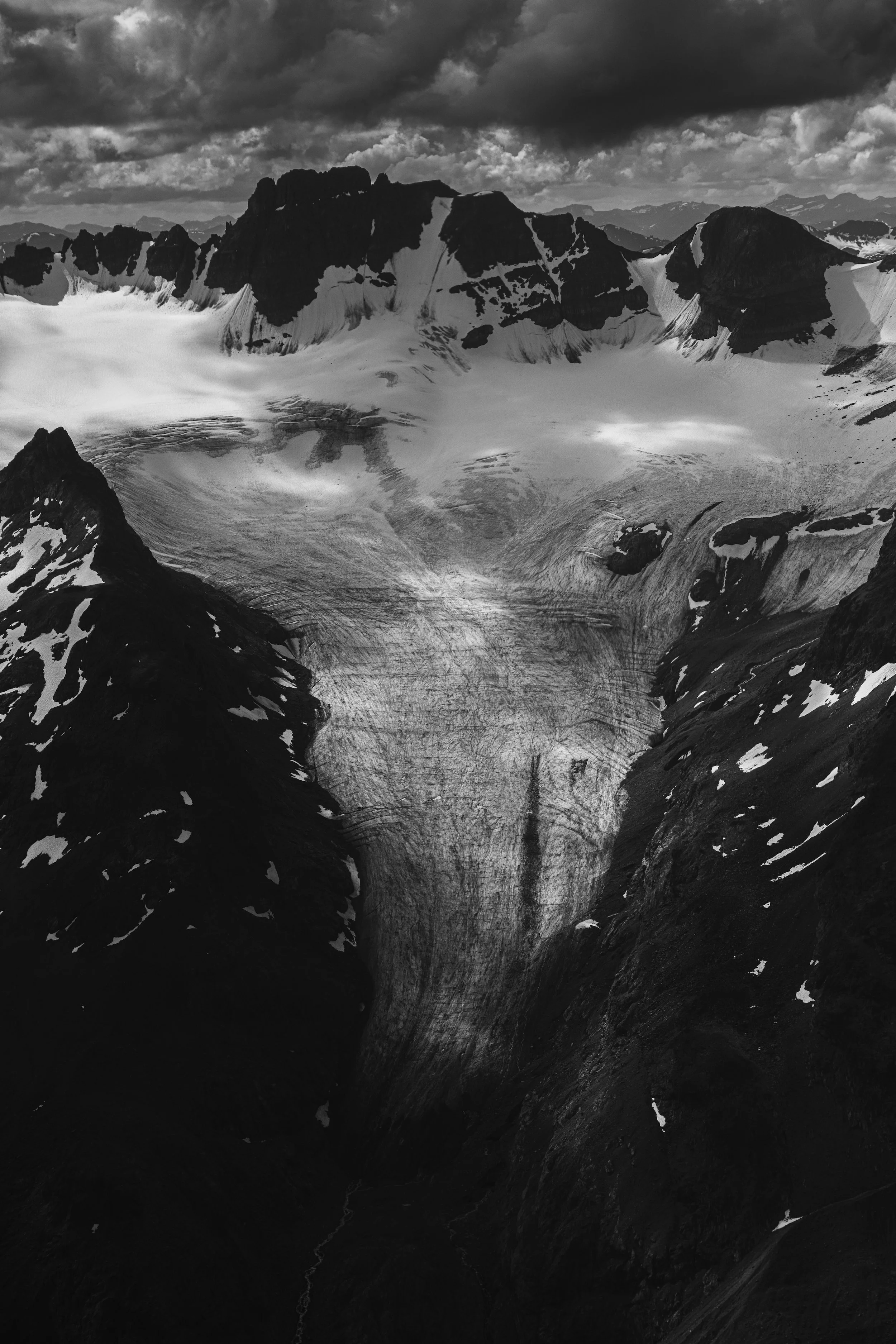 Black and white aerial of a glacier on the sloes of Mt.Will, a peak within the Gladys Lake Ecological Reserve and Spatsizi Plateau Wilderness Provincial Park