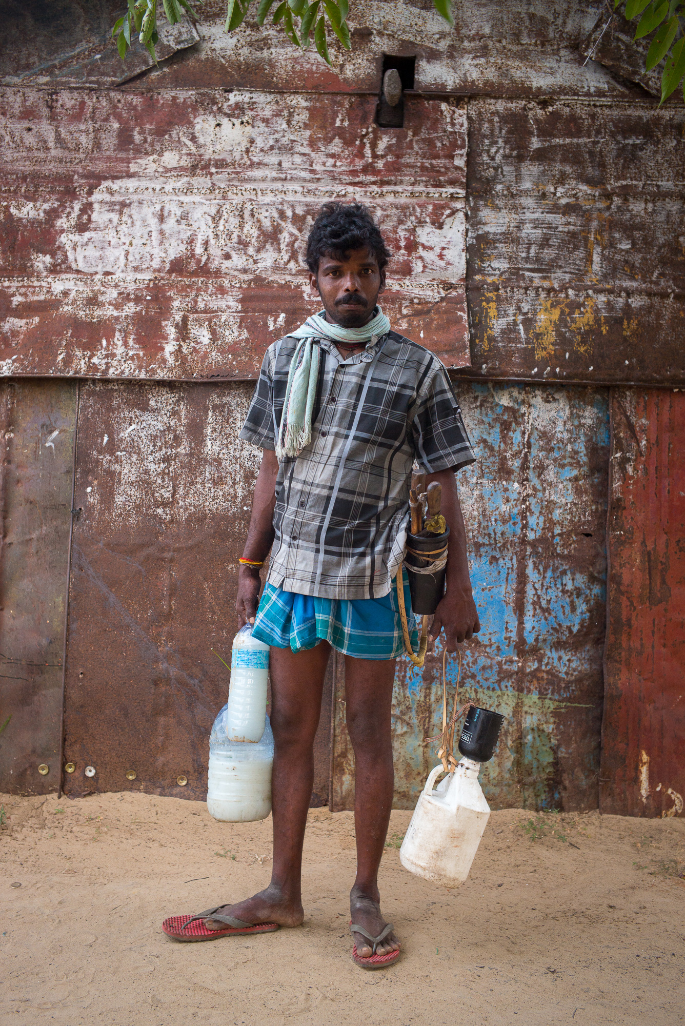 A tapper brings the afternoon’s toddy to the cooperative at Pothikkadu.