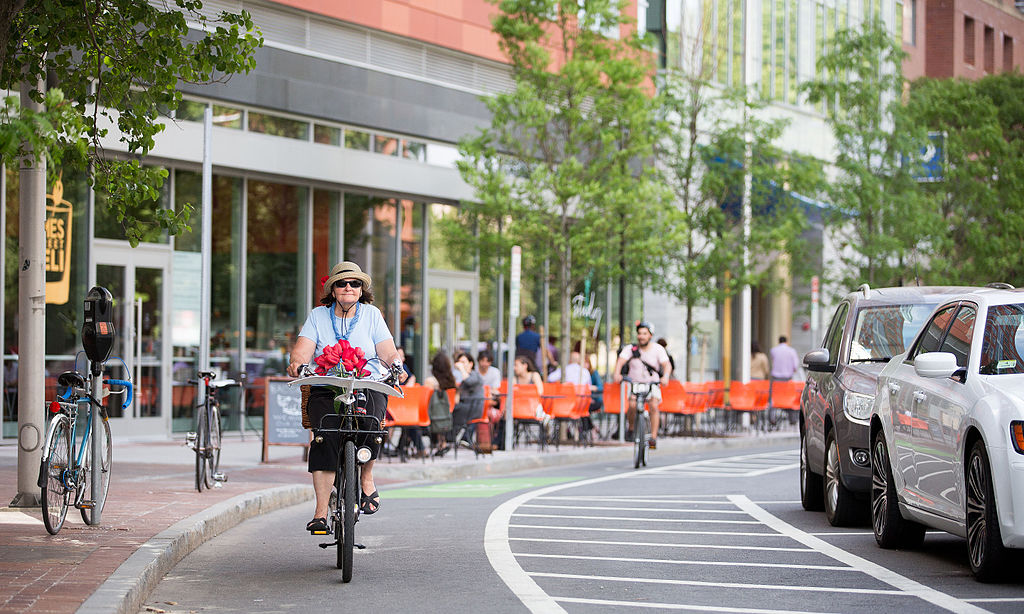 Older_woman_with_flowers_protected_bike_lane_boston.jpg