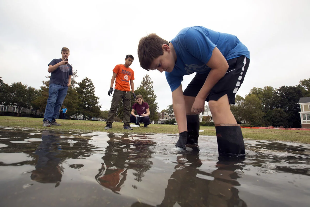 Muck team samples flood waters in Norfolk - Maury High School and Old Dominion University Students (and even a 7th grader in the foreground taking the sample!)