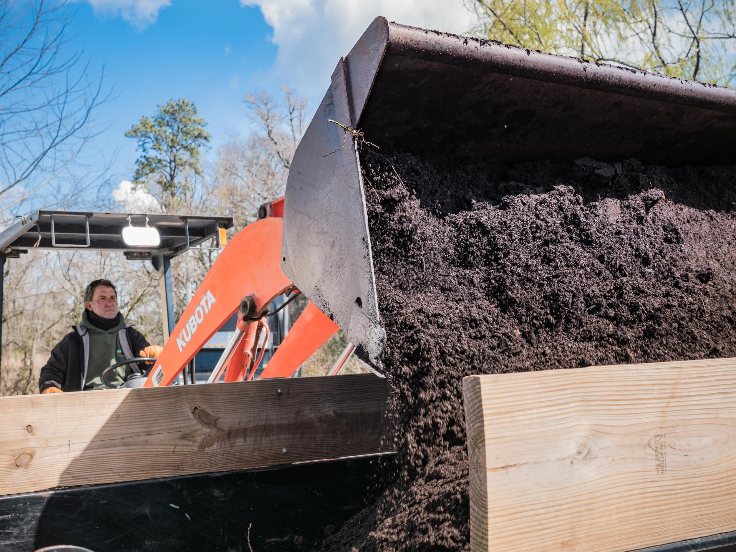 John loading scoops of regrind at the Plant Center.