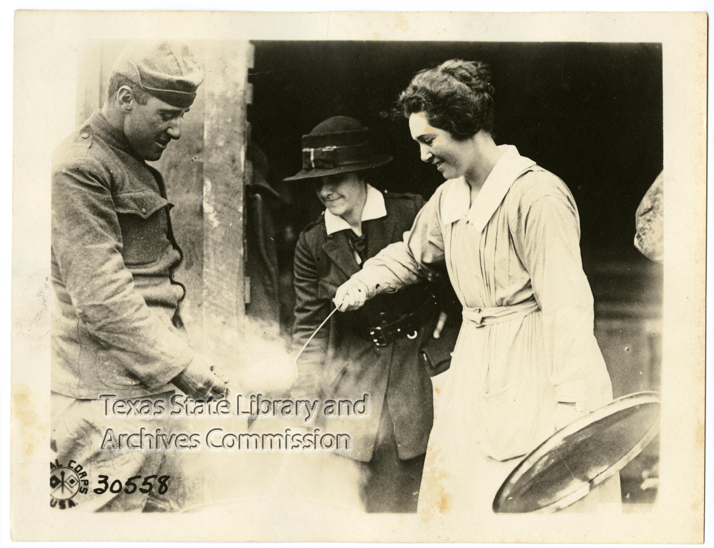  Signal Corps Photo 30558. Miss Adele Birdsall and Miss Thomas, of the American Red Cross, dispensing chocolate to men just in from the line. American Red Cross, Senoncourt, Meuse, France (northeast of Souilly), 1918-10-14, 1972/115-200, Photographs,