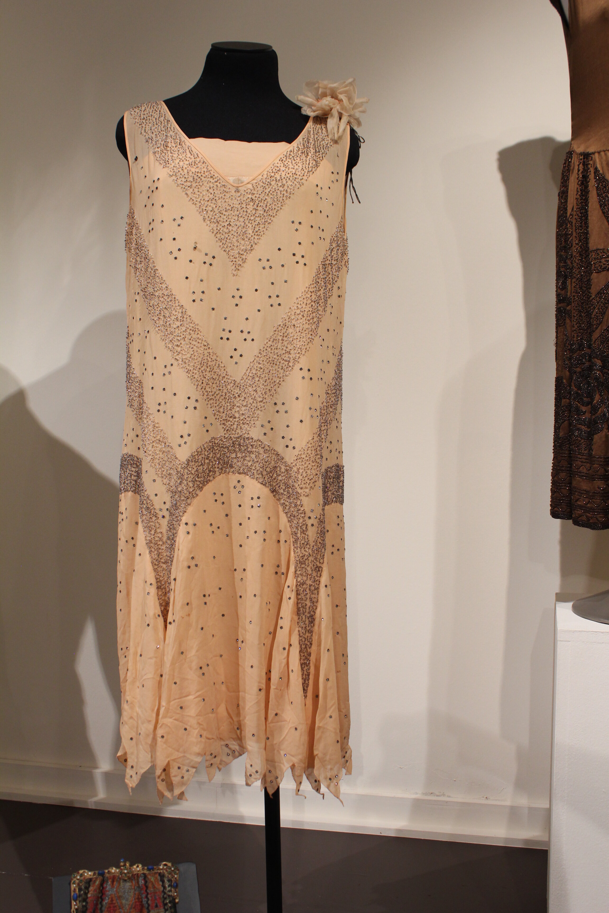 Dress, 1926, silk, diamond sequinsThis peach dress was worn to the Daniel J. Moody, Jr. and Mildred Paxton wedding on April 20, 1926. The Hardin-Simmons website says that their “twilight wedding was one of Abilene’s grandest occasions.” Mildred, bor…