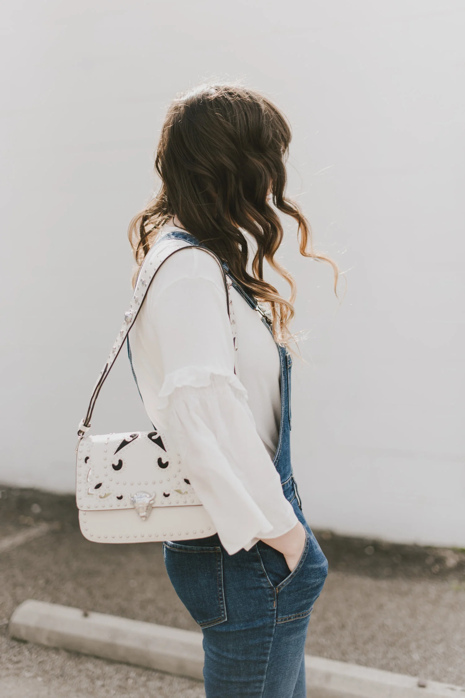 white statement sleeves and overalls