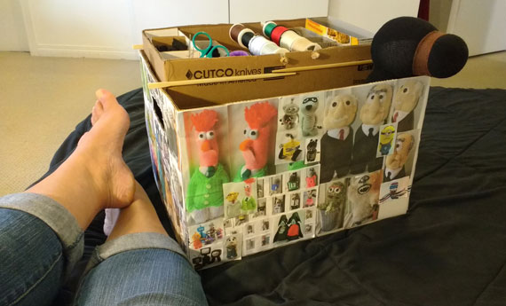 This is a file box that I covered with photos of past creations and use to carry the bigger items like stuffing, and 5-10 sock animal bodies that I'm working on. That's a bear for Jasper "Bear's Paw Bakery" peeking out of the box.