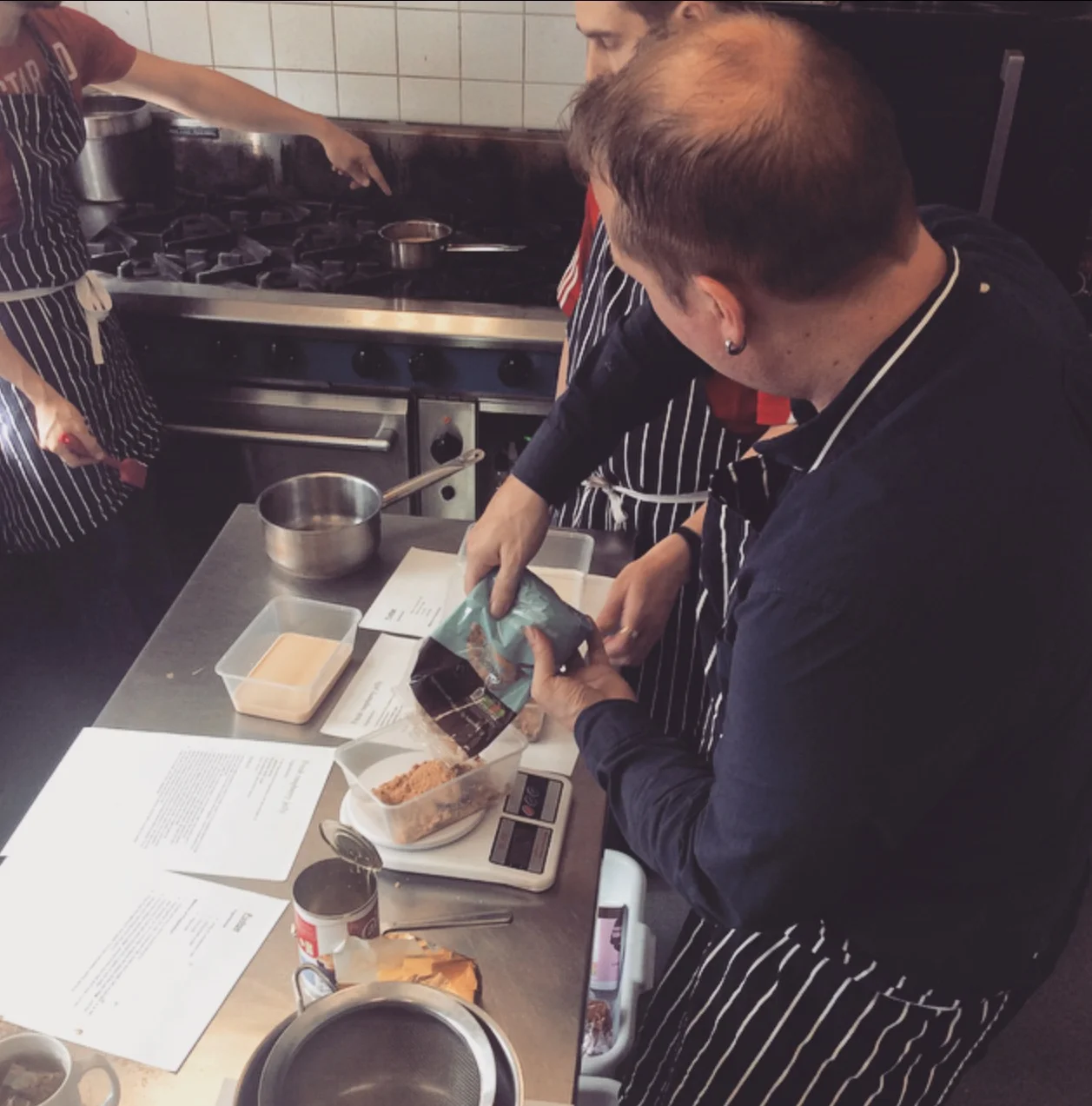 The guys measure out the ingredients 