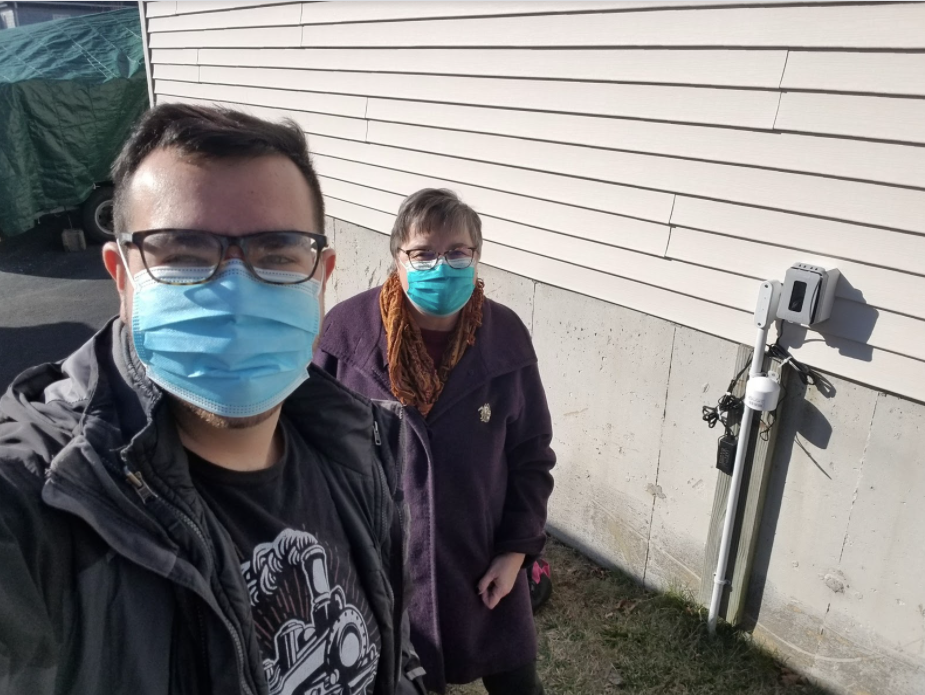 Photos of volunteer board members Alice and Robert installing an air monitor in Quincy Point