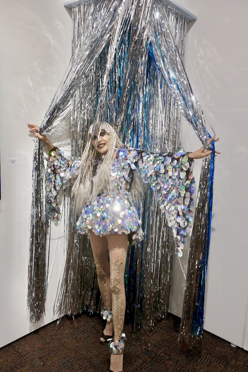 Spotted at Art Palm Springs 2020 with Karen Barone in standing in Jennifer Henry’s silver curtain at Spotlight on Hi-Desert Artists curated by Michael McCall