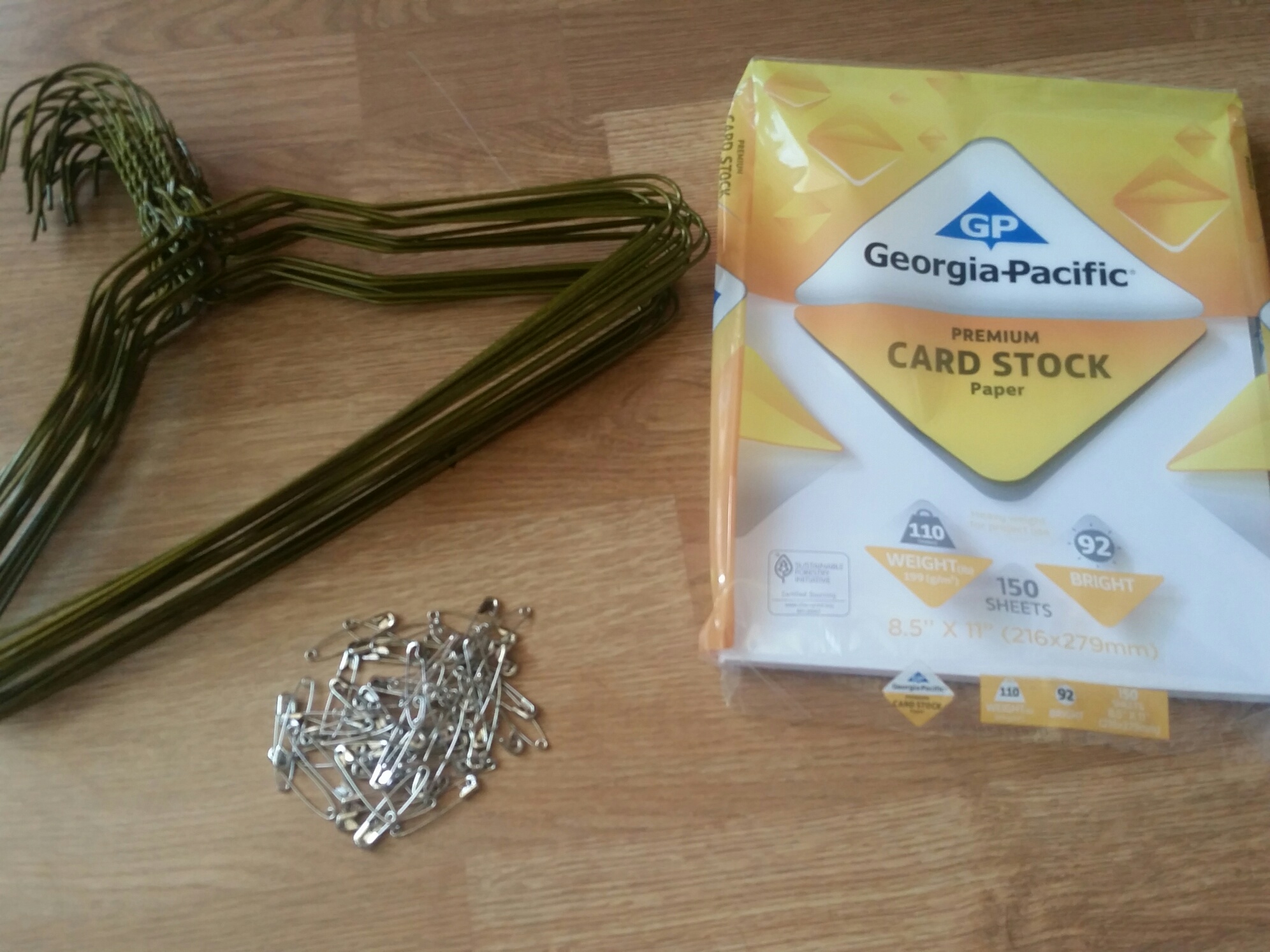 Child size hangers, Safety pins (1.5 inch), White cardstock