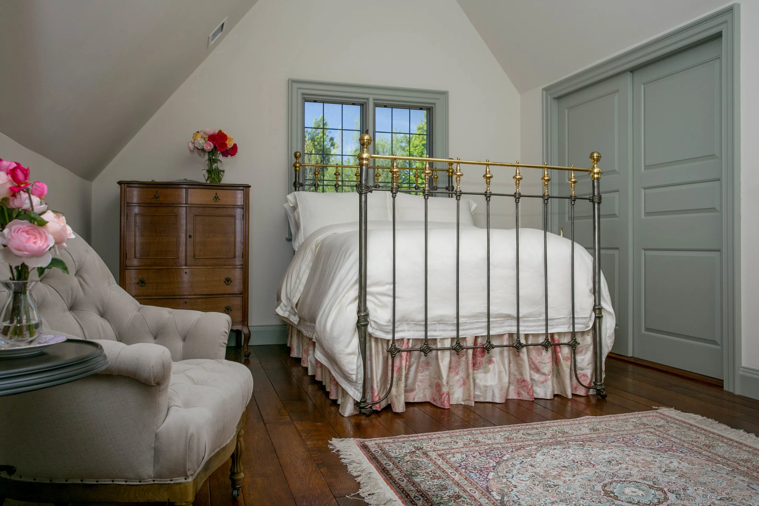 Upstairs is an English antiqie brass & cast iron bed with silk dust ruffle