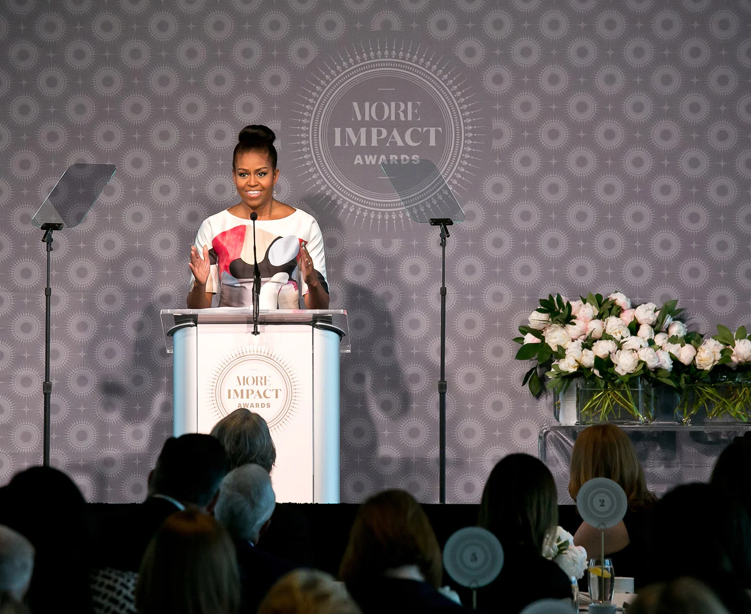 Stage backdrop and podium sign, table number cards (foreground). MORE Impact Awards. Creative Director: Heather Sears