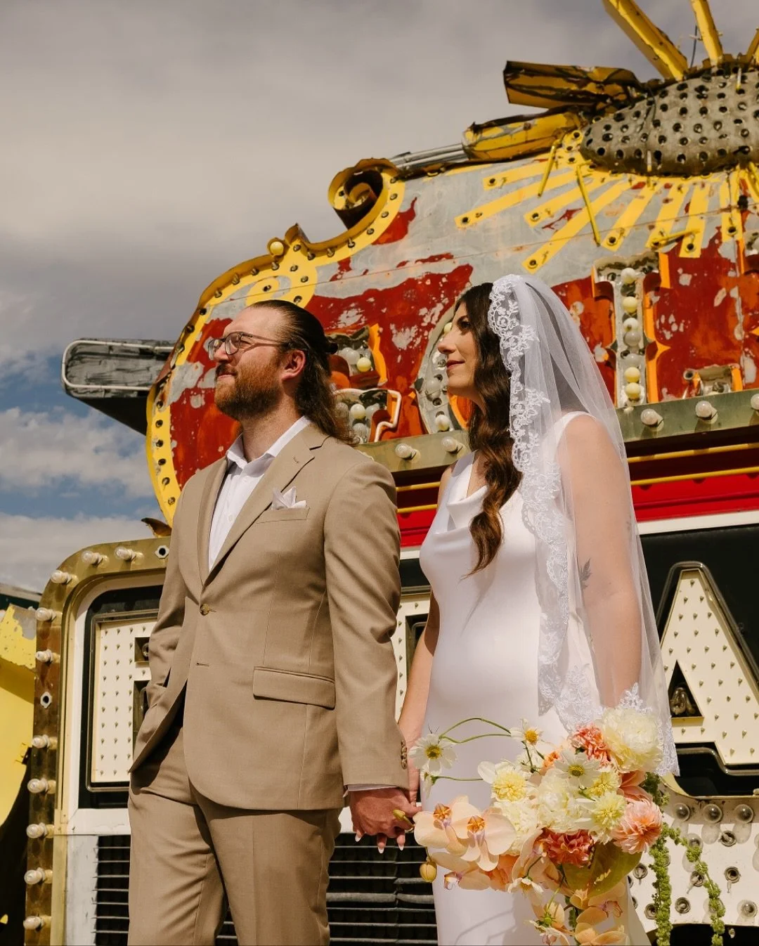 Stoked to share a few photos from the day we hung out with Dolly &amp; Drew ❤️&zwj;🔥 featuring one of my favorite flat-lays of all time, a first look and private vows at the Neon Museum, and a juggling groom (plus, an absolutely perfect bouquet from