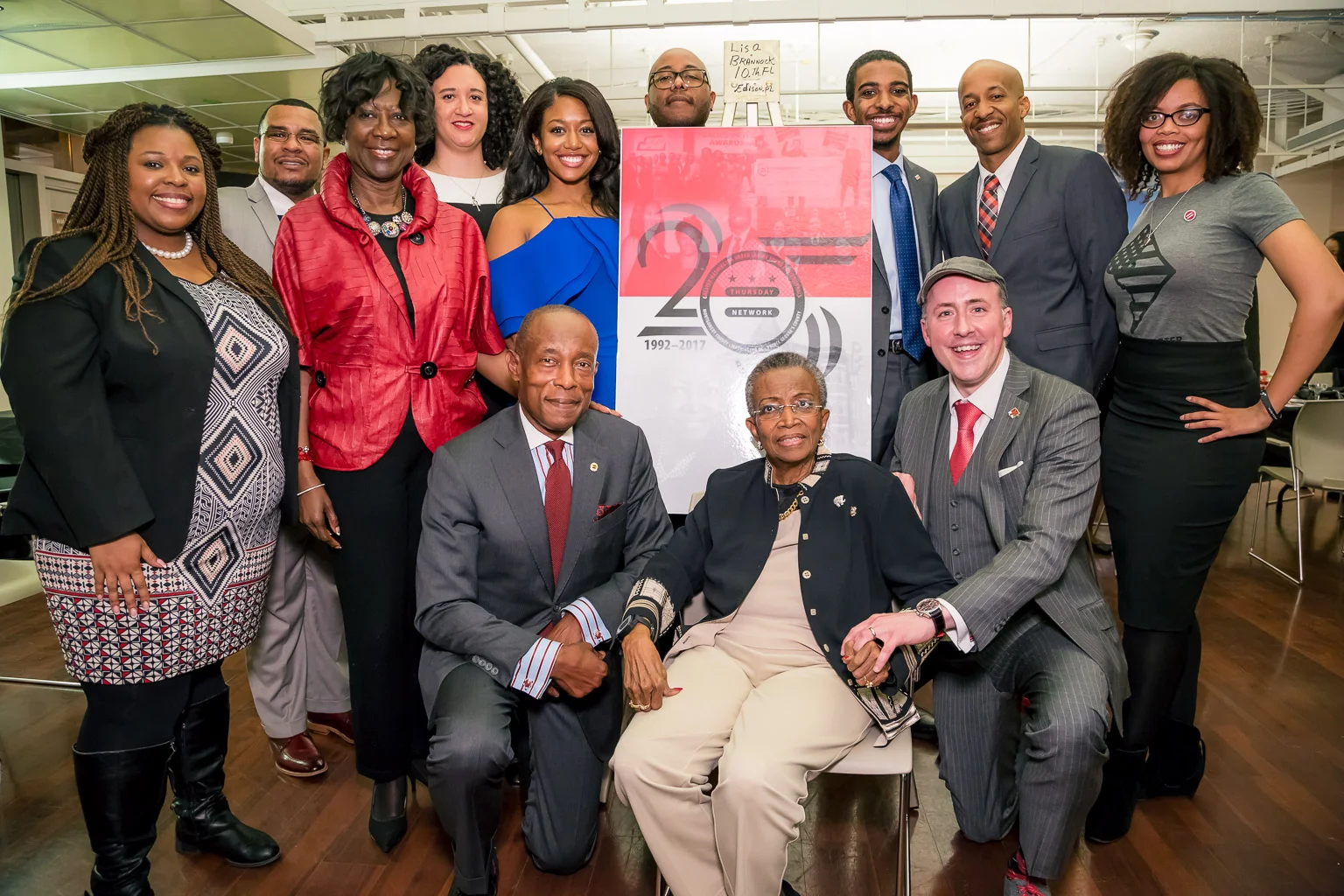 Maudine Cooper (center) surrounded by those who serve the community through the house that she built.