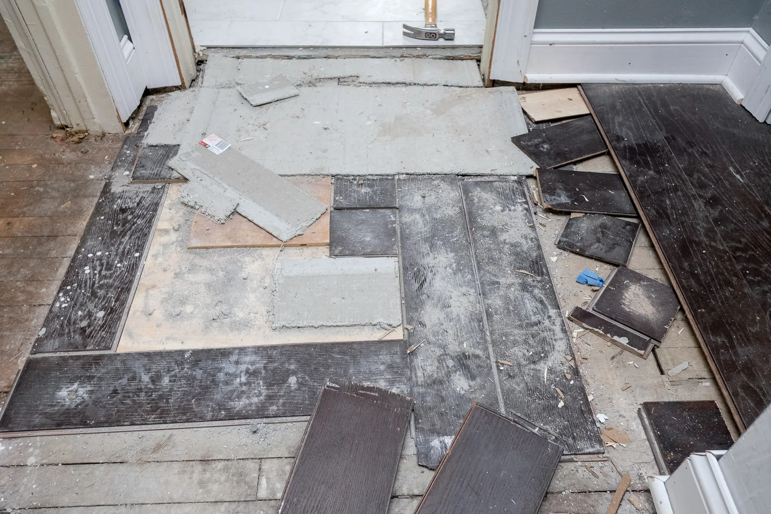 Rather than install a proper underlayment, thievery and incompetence led to the initial contractor using wall board and pieces of the new hardwood as an underlayment. There was such a pronounced change in elevation in this part of the floor, it felt like you walked onto a pitcher's mound.