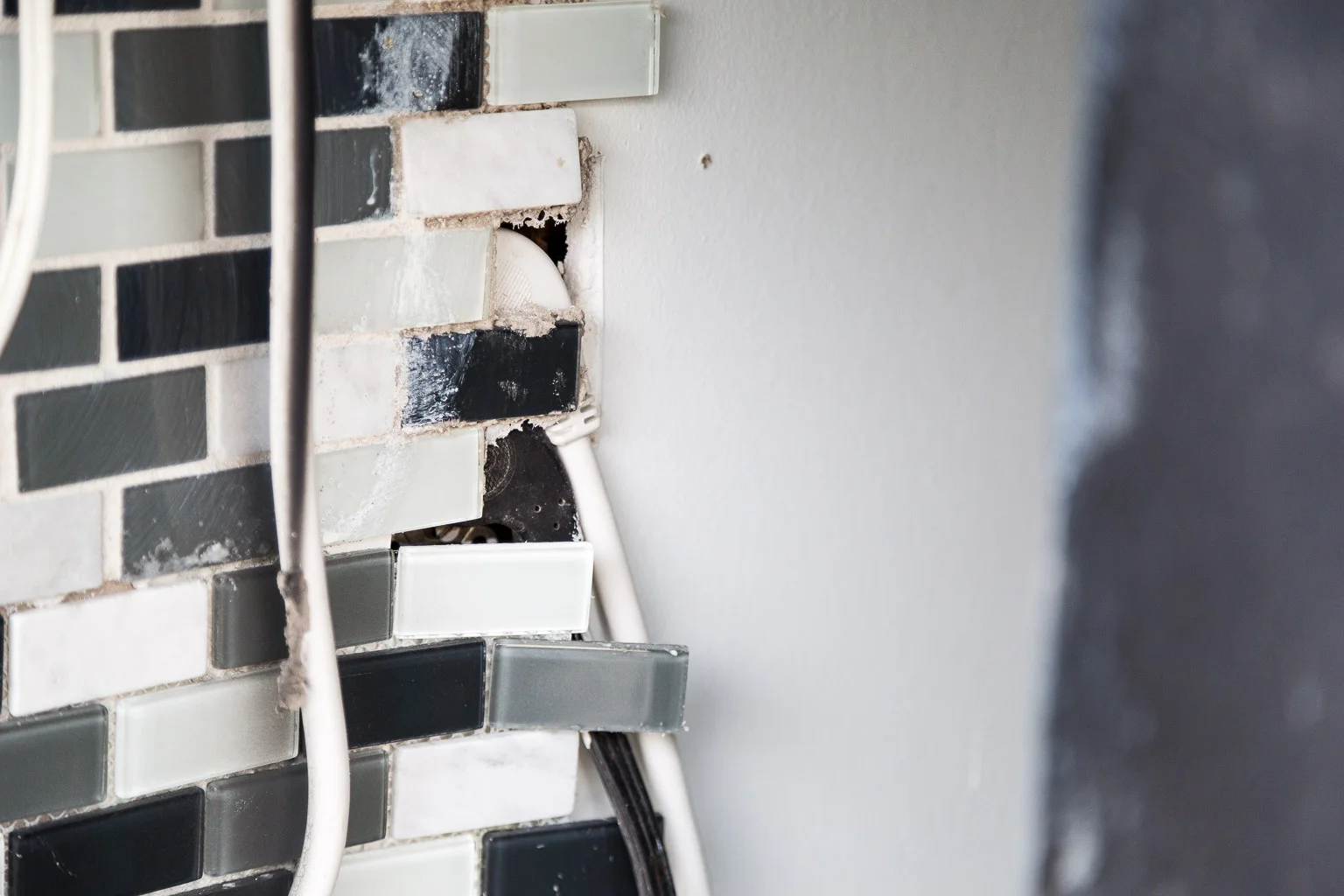 What you see here is the work of pure idiots. They tiled over the electrical outlet.