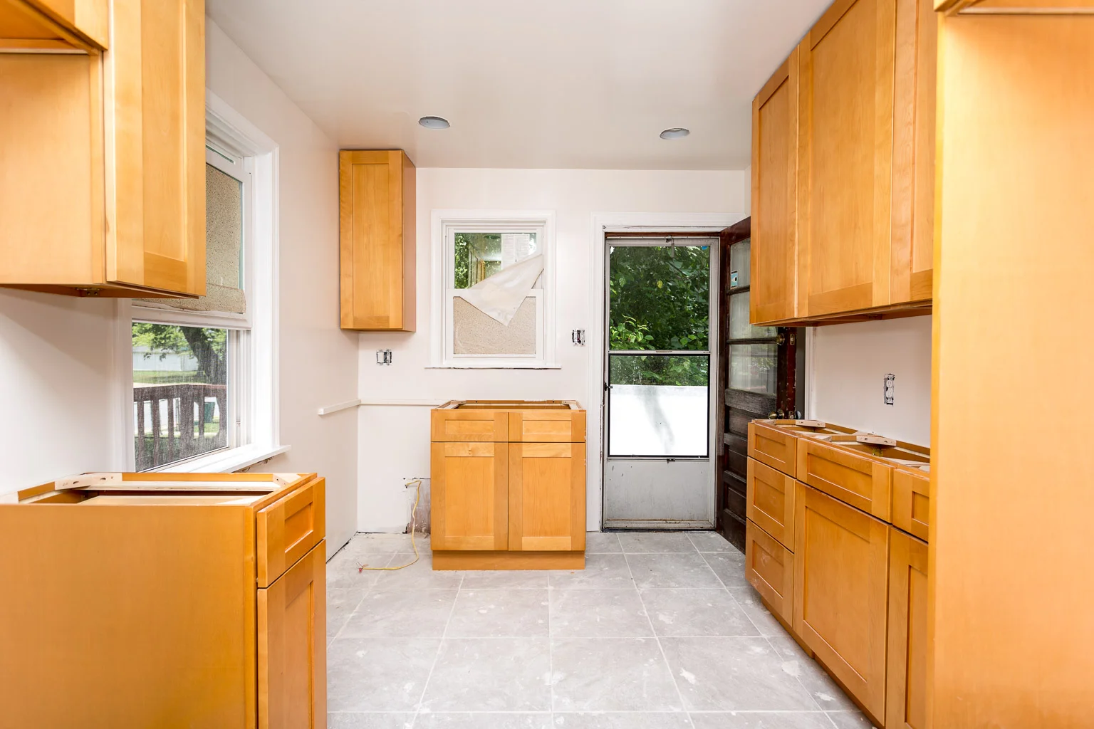 There's recessed lighting now and cabinets that are actually installed properly. The gas line is moved from the right side of the room near the door to the bottom left corner of this photo to create a better flow in the kitchen. All that's left to install is the countertops and the appliances.