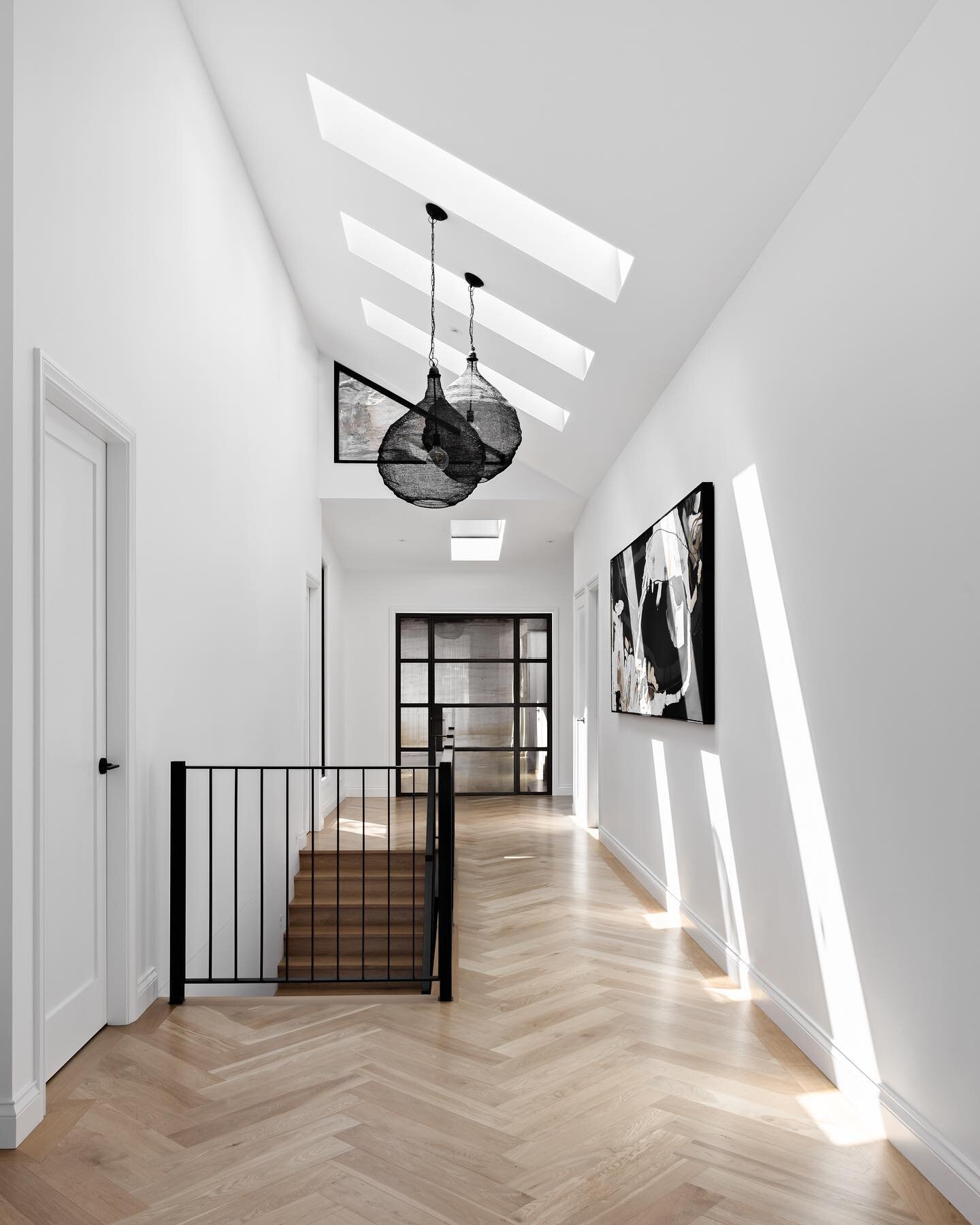 The beautiful entrance of our House on the Water project! The raked ceilings, the sky lights, the natural light flooding in and the herringbone flooring make this the most grand entry areas I&rsquo;ve ever had the pleasure of working on 🤍