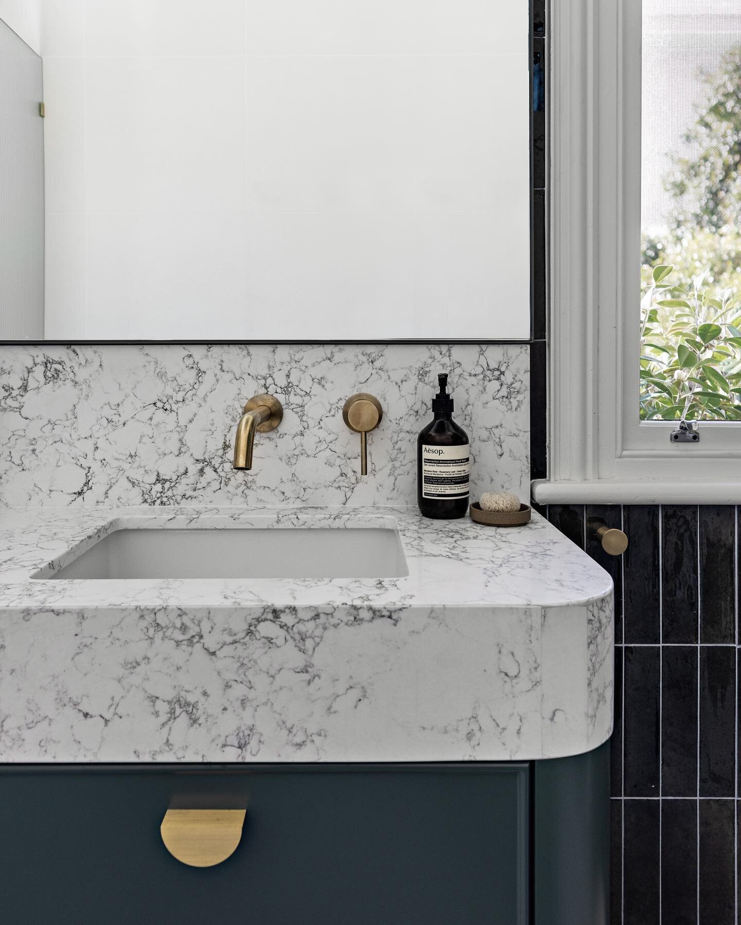 The laundry and main bathroom all rolled into one space in our Annandale project. Our lovely clients told us they wanted colour, so we chose a beautiful emerald green for this space. It feels so rich and decadent, the brass tapware and hardware was t