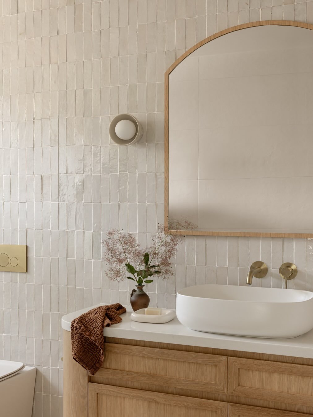 The bathrooms at our Loftus project feeling all warm and cosy thanks to the beautiful timber vanities. Lots of texture in the tiles, neutral warm colour palette and the custom steel doors made by our talented client @jsbalustrading made these bathroo