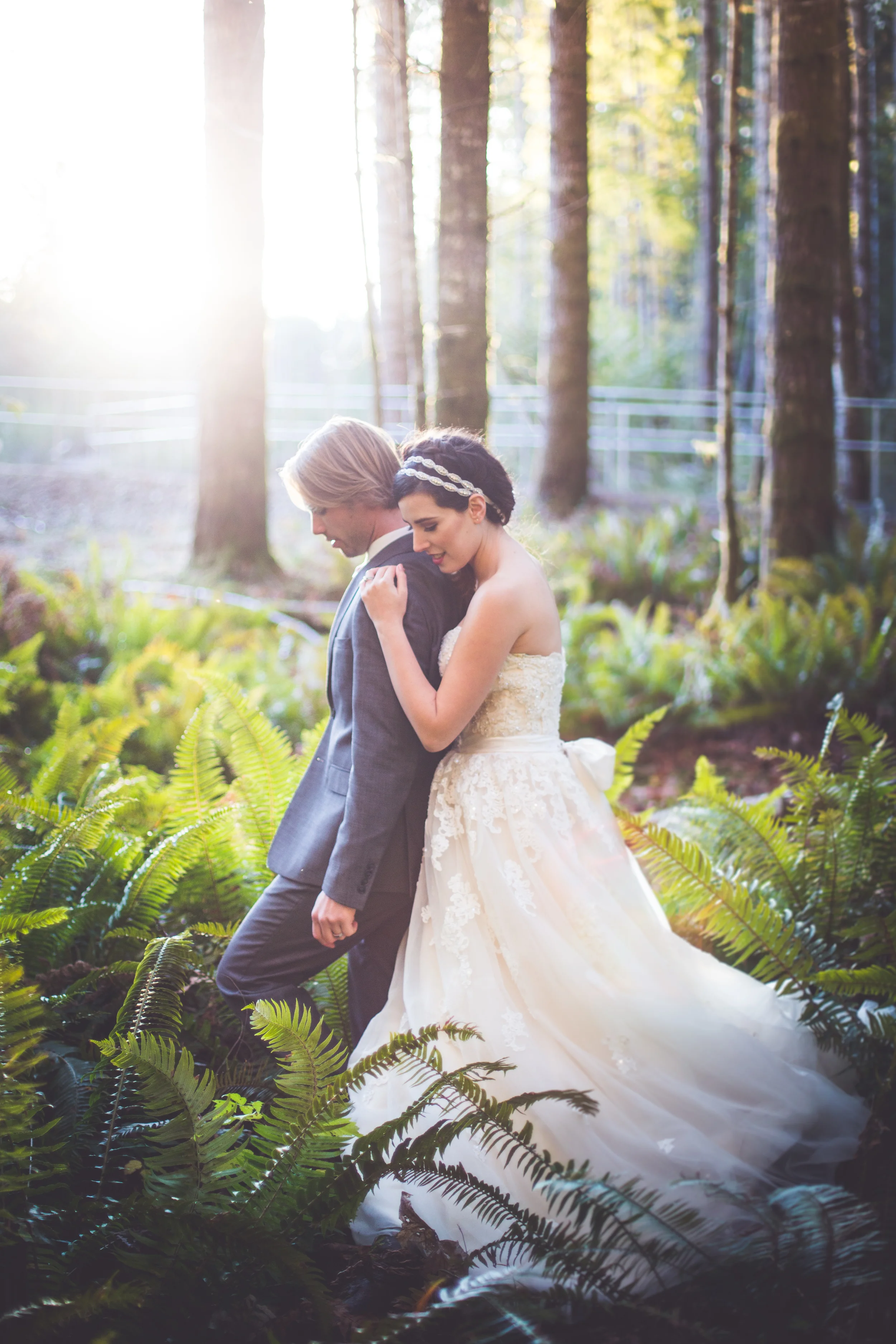 bride and groom walk through ferns at elk falls park wedding