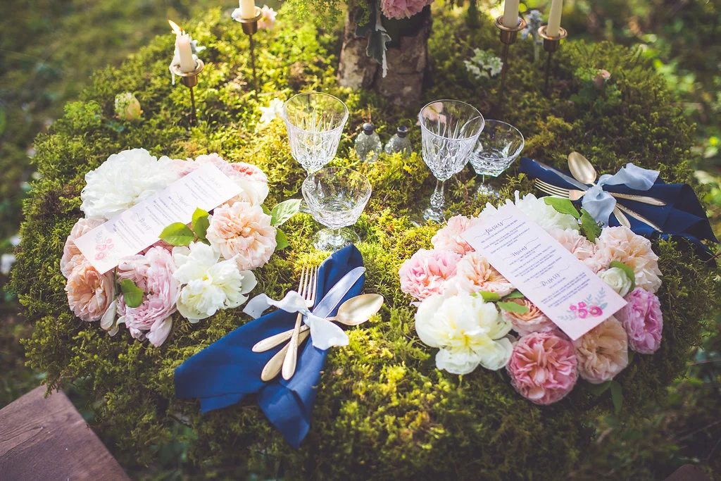 moss covered table with floral charger plates in romantic qualicum beach elopement