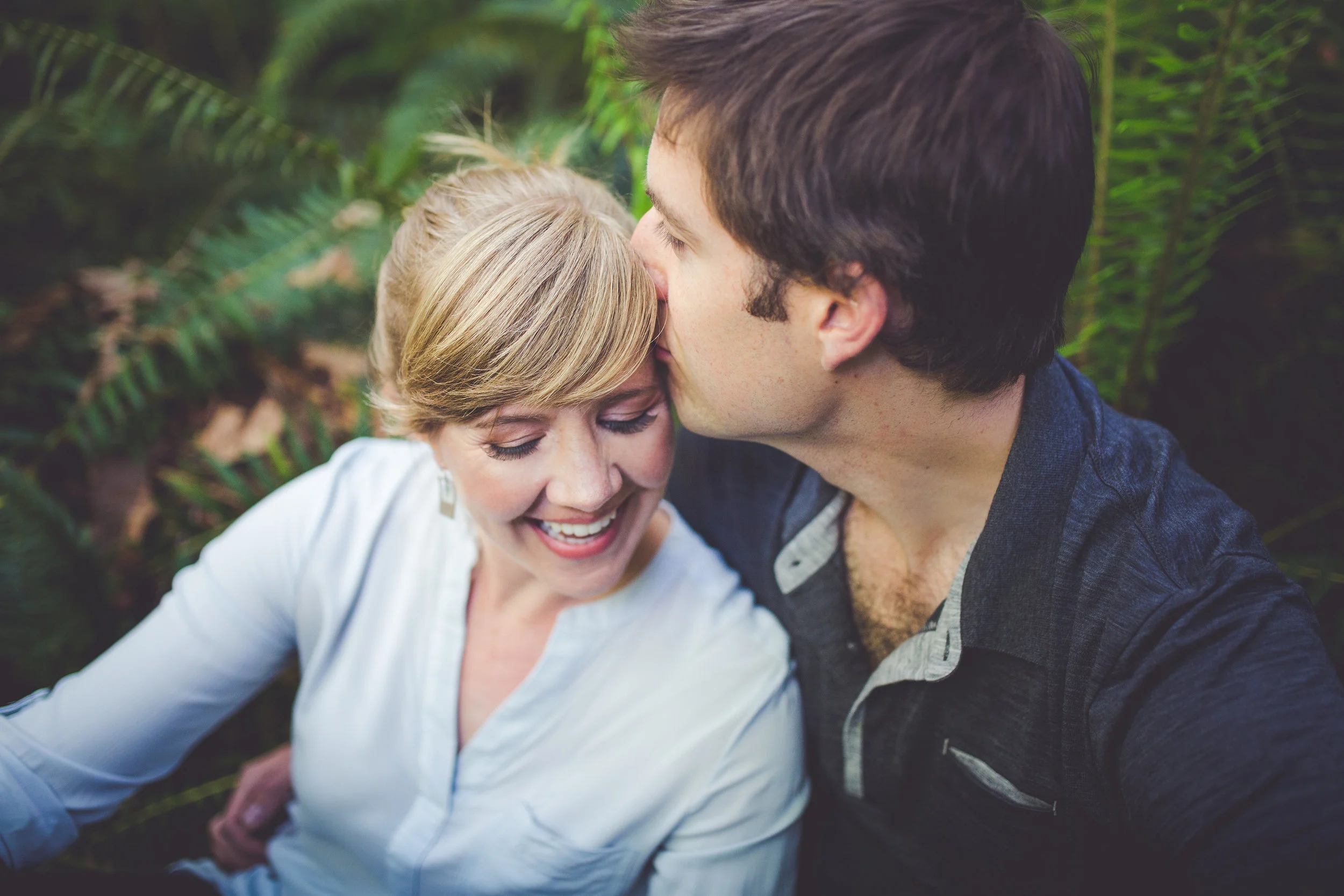 couple in ferns for engagement photos at rosewall creek