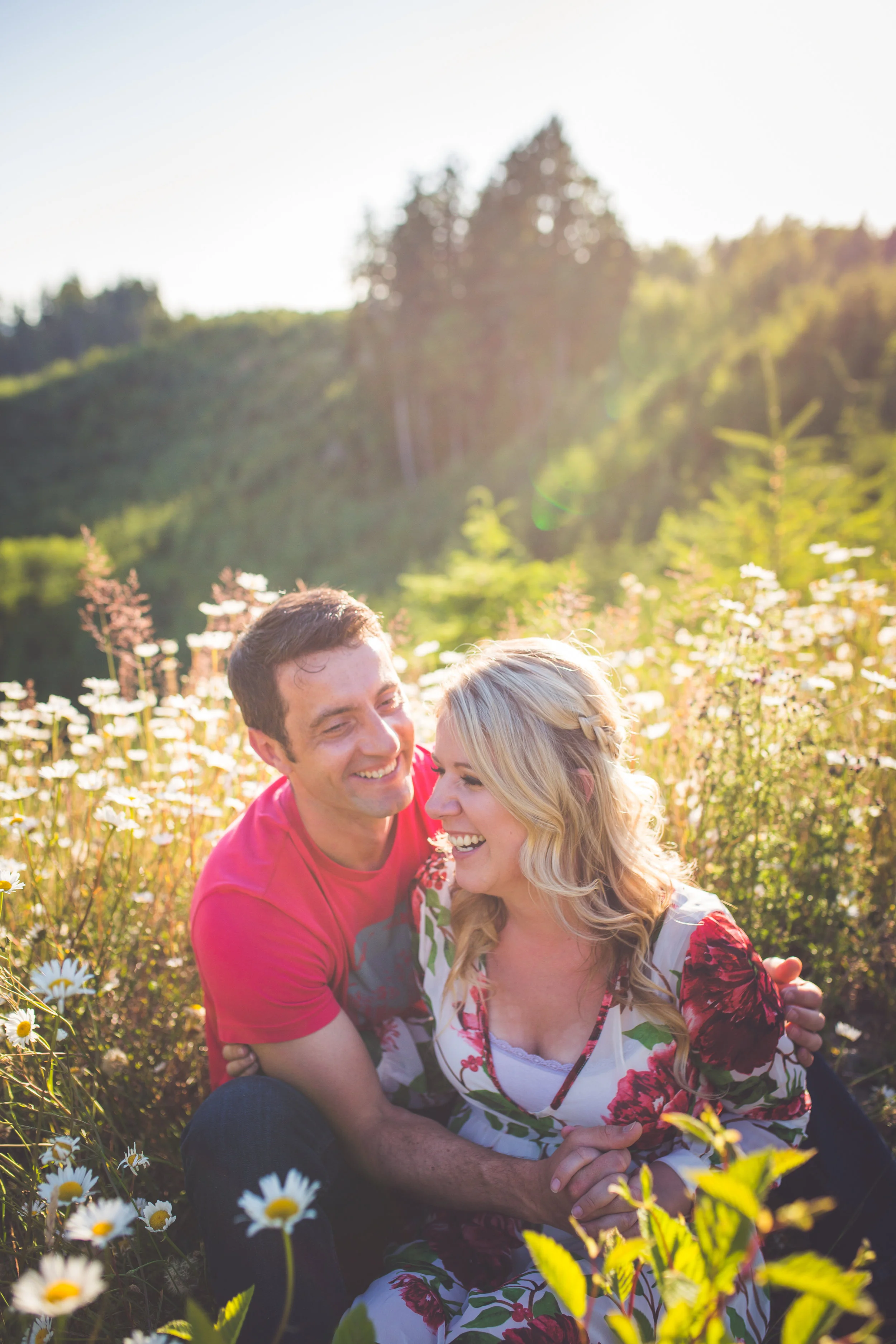 couple laughs during sunset engagement session
